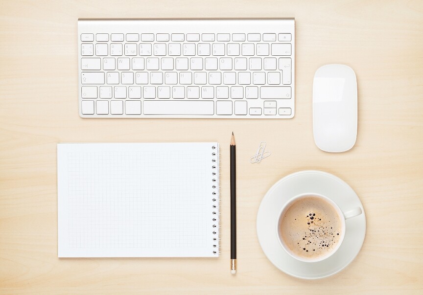 Desk with mouse keyboard and paper