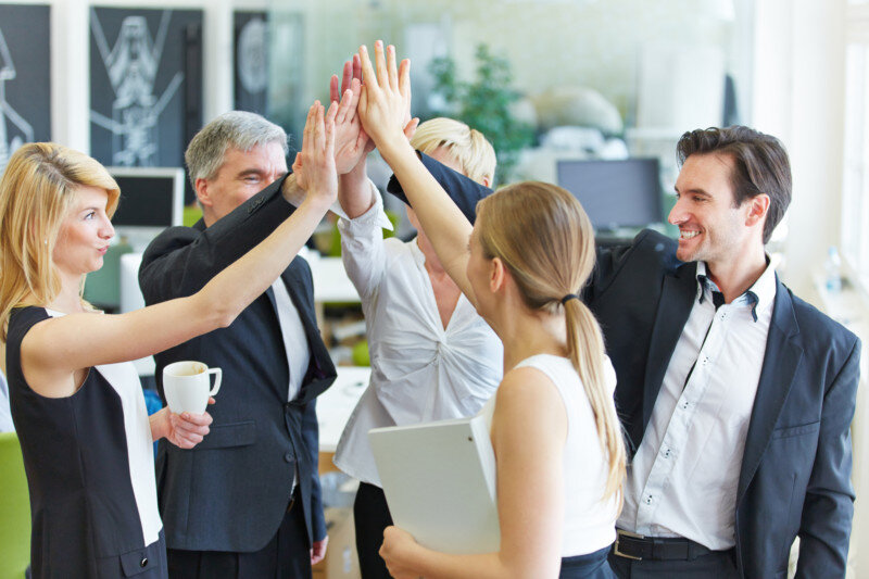 Business people giving high fives