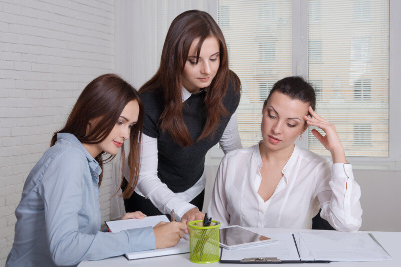 Three Woman Working on Business Documents