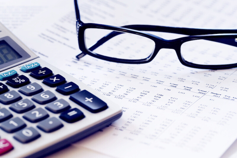 Financial statements with glasses and calculator
