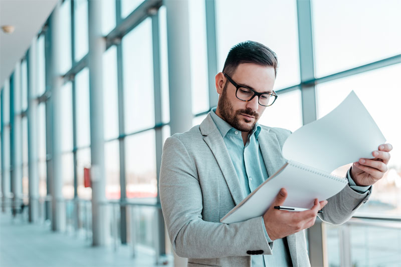 Man Looking at Reports