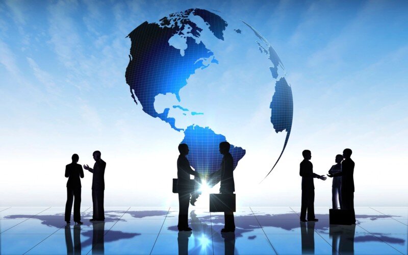 conceptual image with business people standing in front of globe