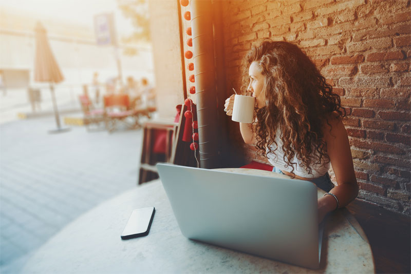 Woman Working Remote at Cafe