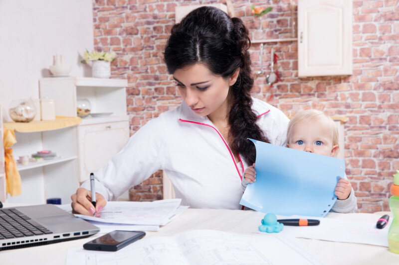 Woman With Baby Working From Home