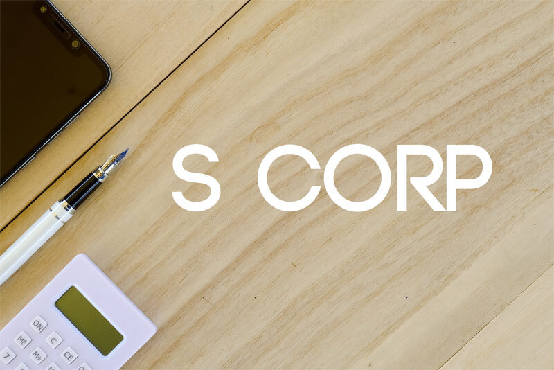 Desk With S Corp Written On It