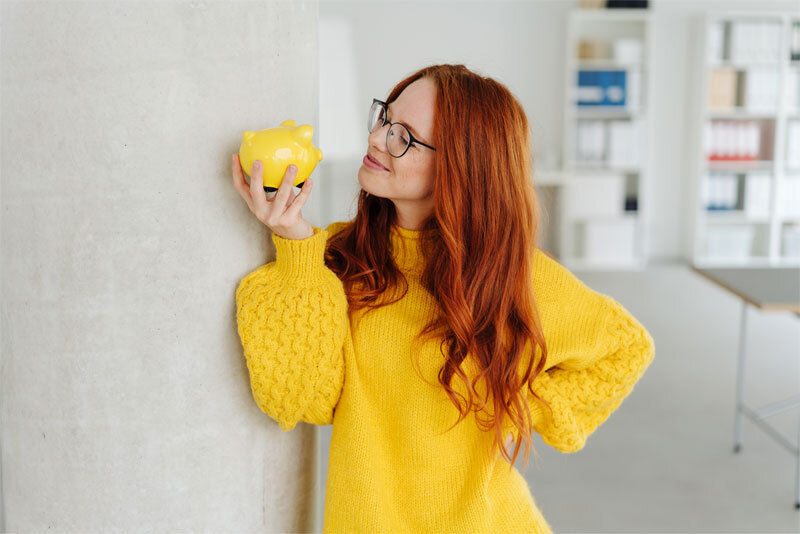 Business Woman Holding Piggy Bank