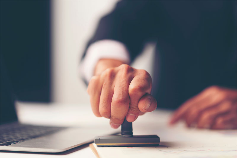 Man Stamping a Legal Document