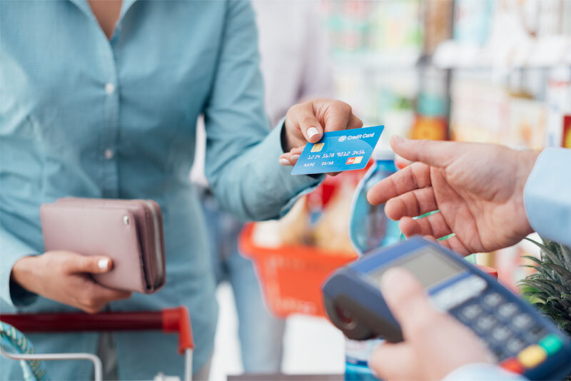 Woman at Store Checkout with Credit Card