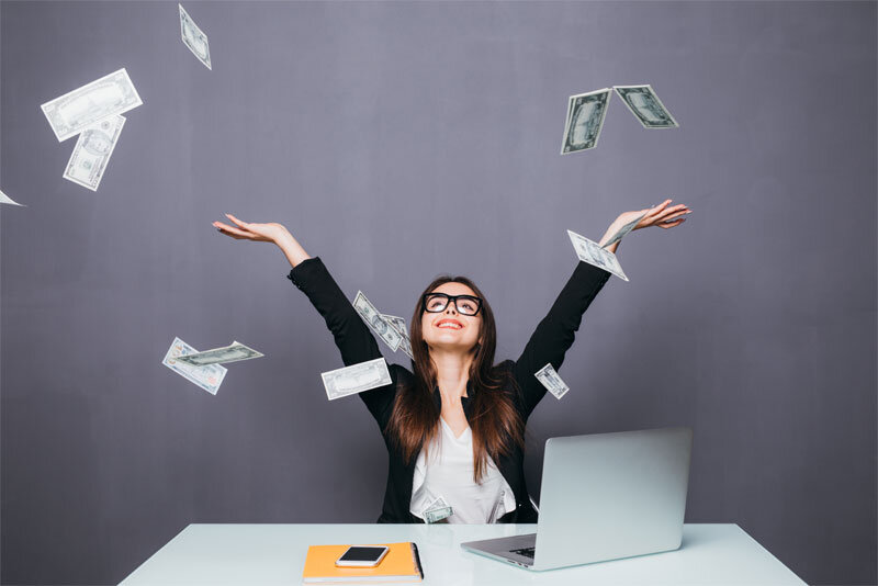 Happy Woman Throwing Money Above Laptop