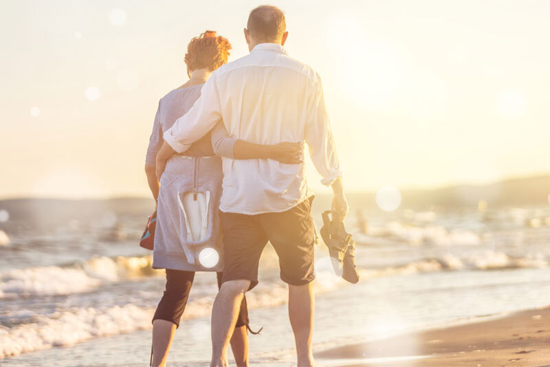 Retired Couple Walking on Beach