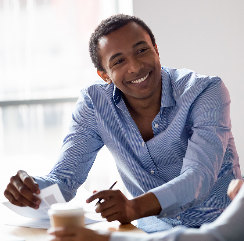 Man Smiling Over Paperwork