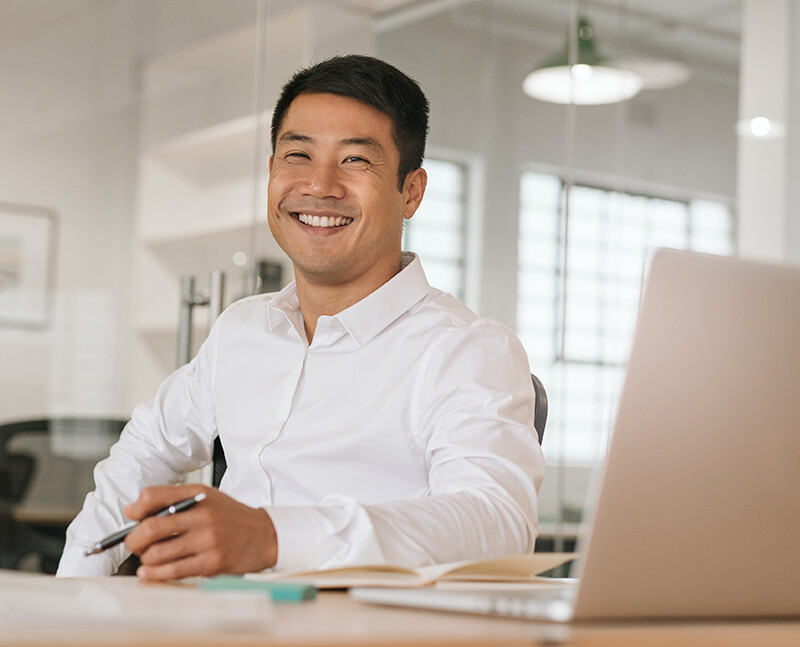 Man Smiling at Computer