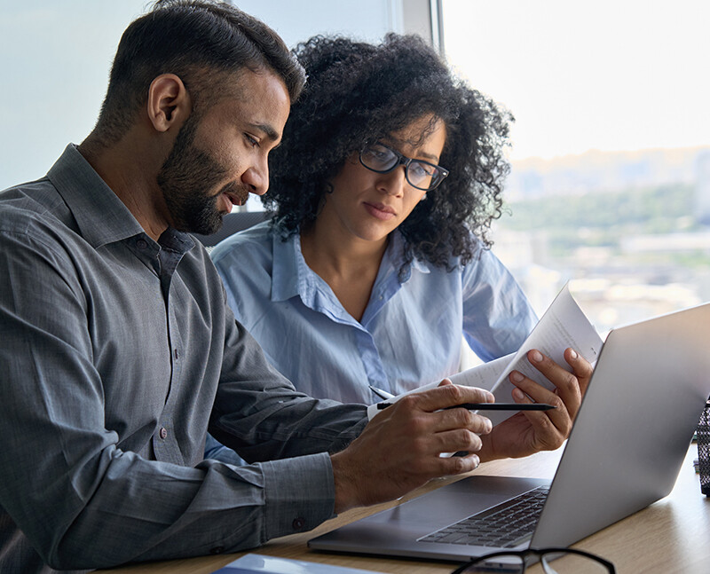 Man and Woman Looking at Paperwork