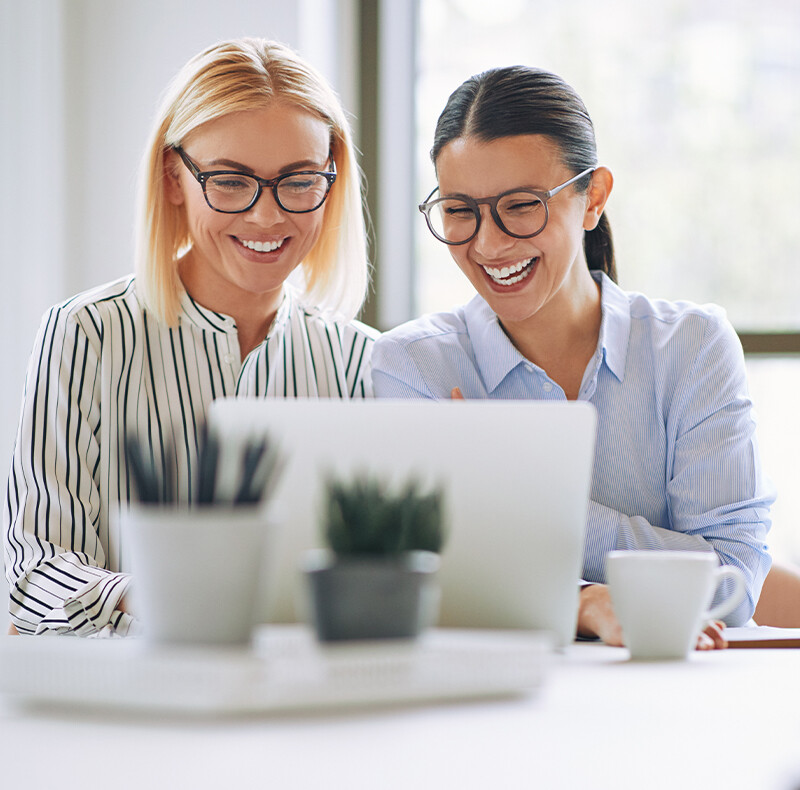 Two Women Working on Laptop