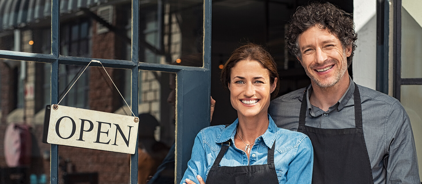 Couple In Front of Store With Open Sign