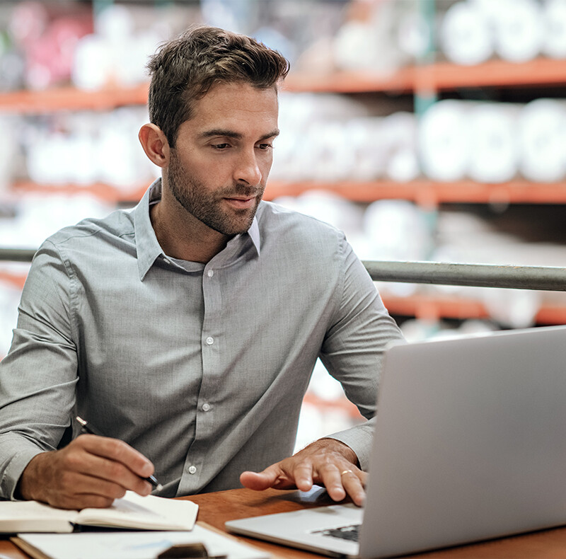 Man in Grey Shirt at Laptop