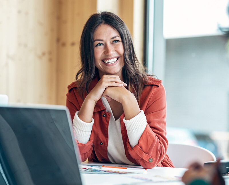 Woman Smiling at Desk