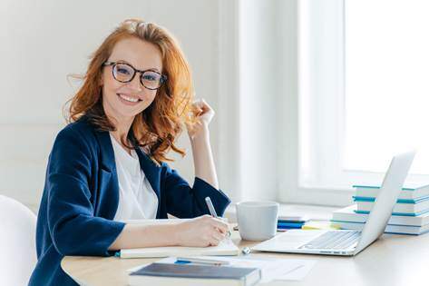 Smiling Woman at Laptop