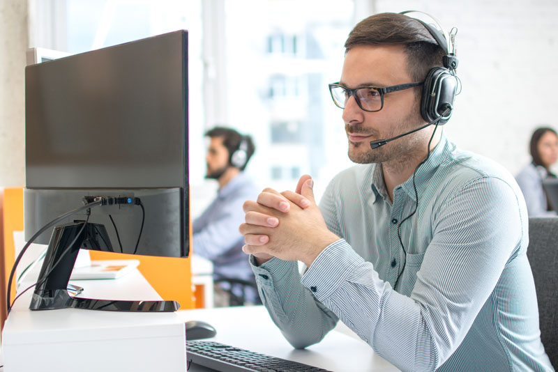 Businessman Working at Desk and Talking on the Phone