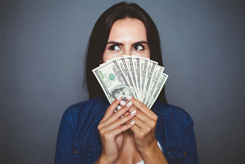 Woman Holding a Handful of Money