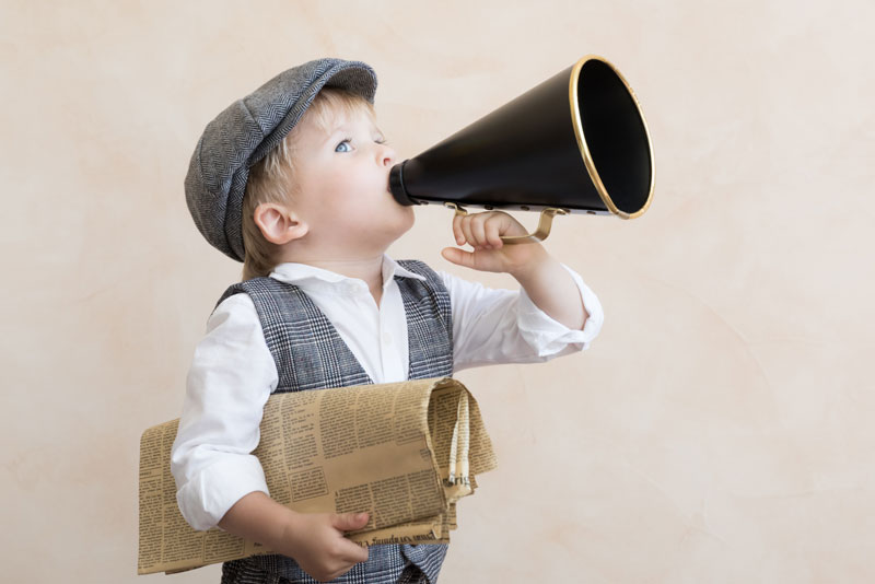 Small Boy Holding a Newspaper