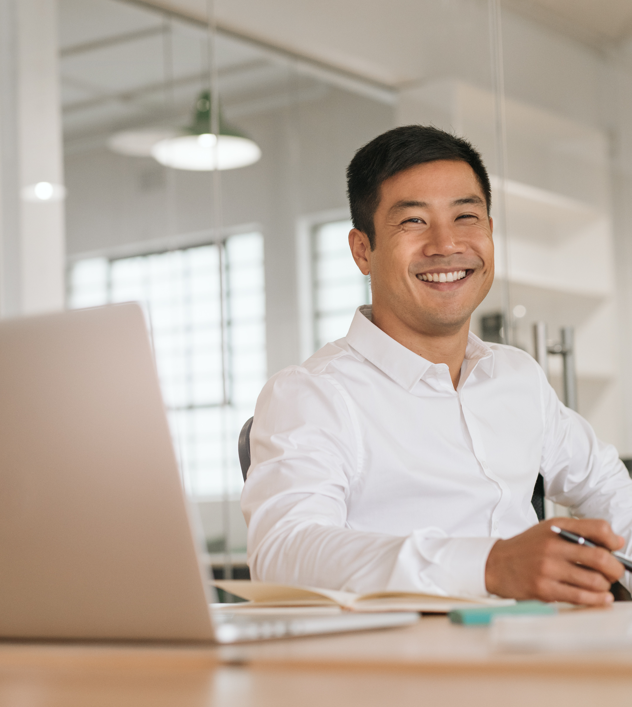 Man Smiling At Work Smiling Asian Man Working on Laptop